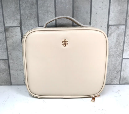 Beige cosmetic case with a brand logo on a gray tiled background