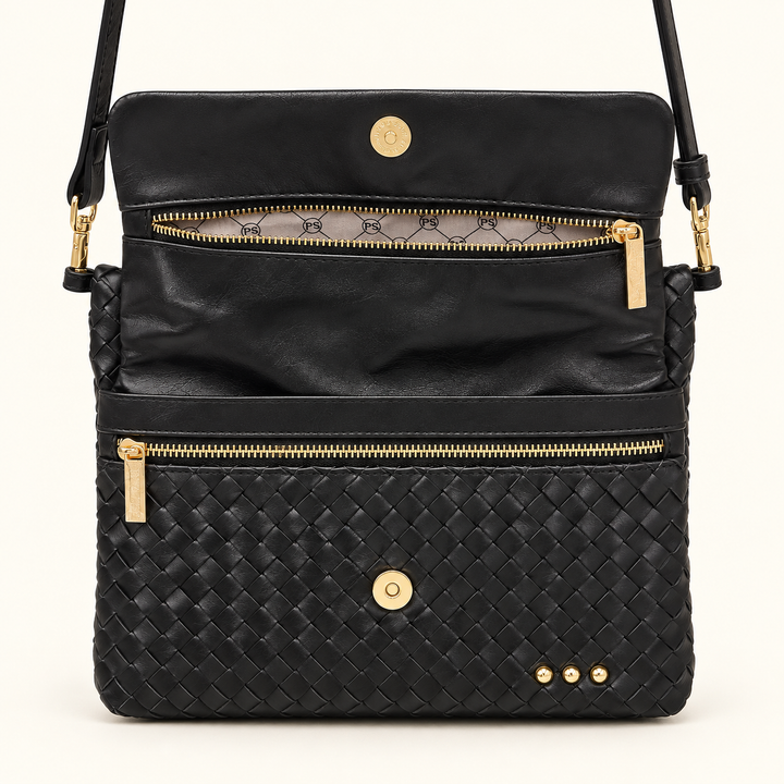 Open Wrenlee Woven Flap Crossbody showing the interior compartments, zipper pockets, and gold-tone snap closure.