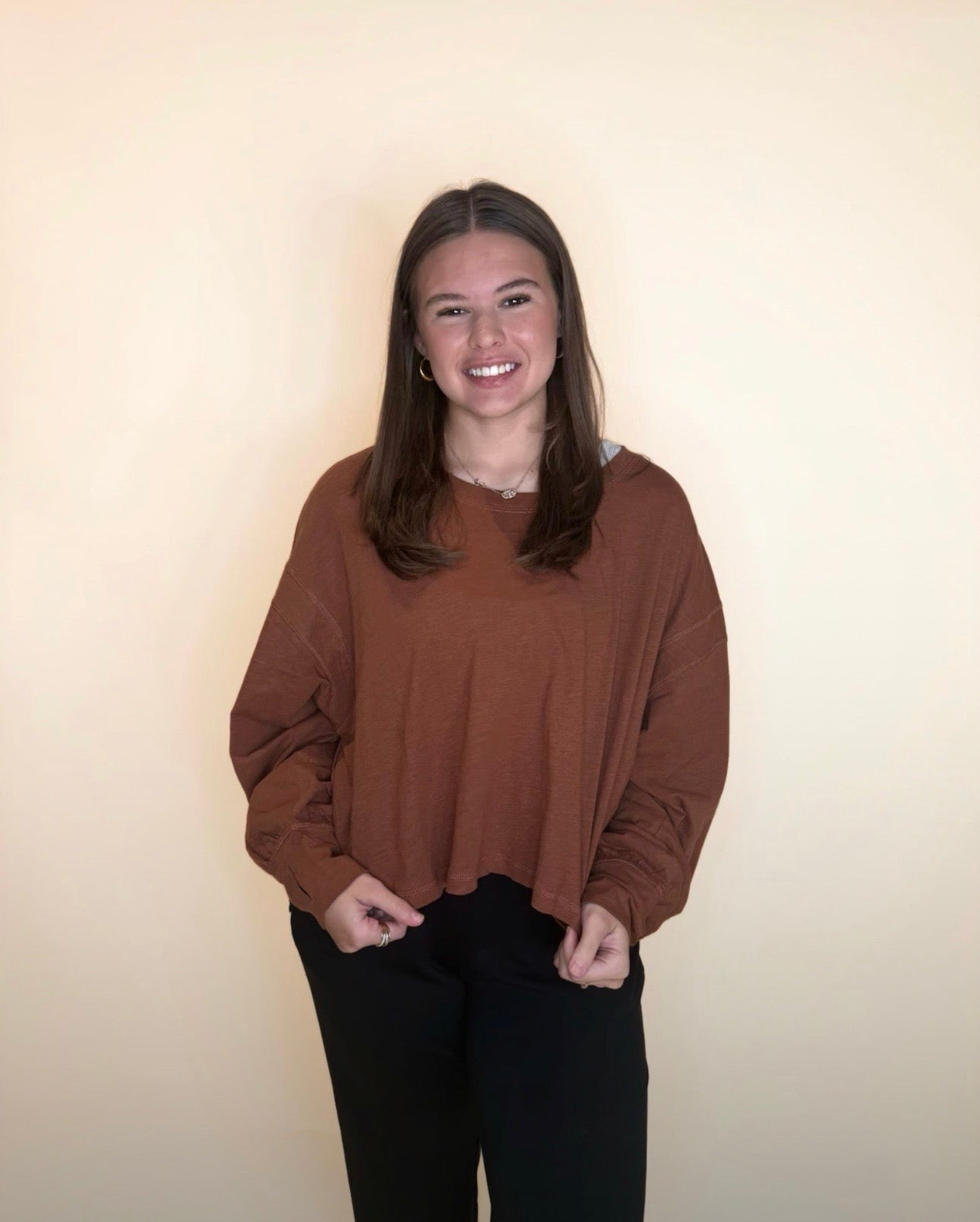 Warm cinnamon brown oversized long sleeve top with black pants, soft relaxed fit perfect for fall styling.