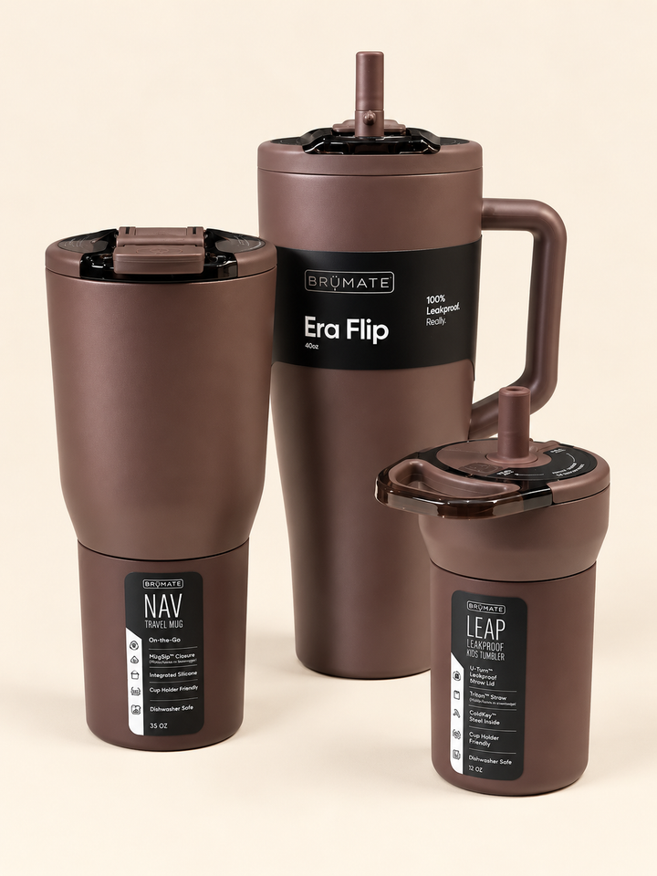 BrüMate insulated drinkware collection in matte brown featuring the 40oz Era Flip tumbler, 35oz NAV travel mug, and 12oz LEAP kids tumbler with coordinating lids on a cream studio background.