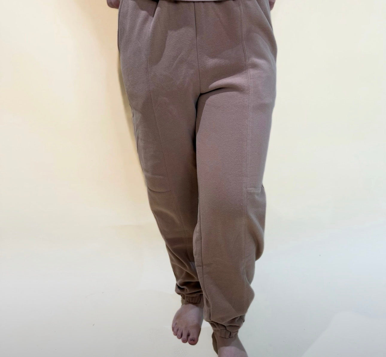 Front view of taupe jogger sweatpants with elastic waistband, relaxed leg fit, and casual everyday style.