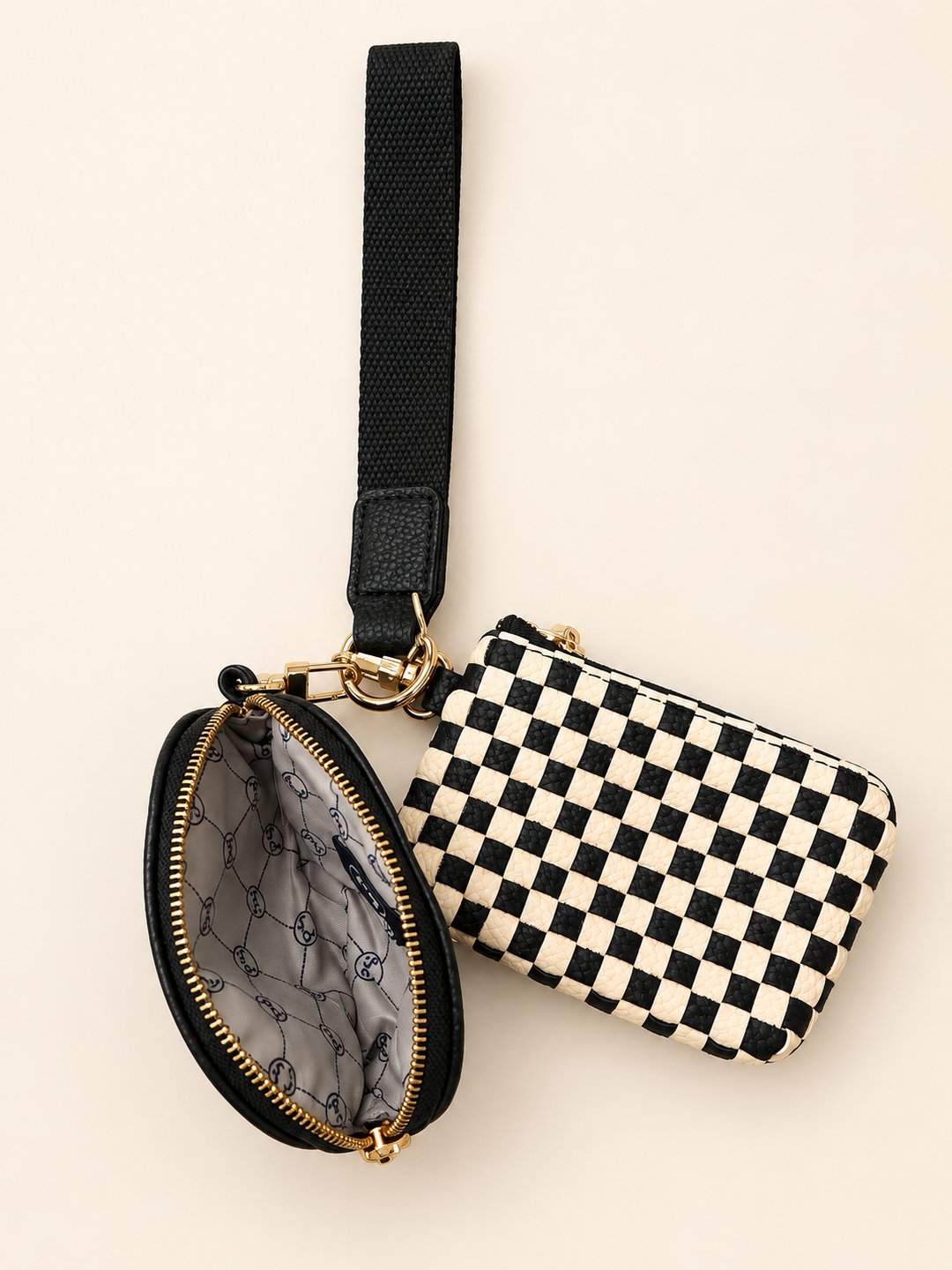 Open Black Checkered Wonderlust Dual Pouch Wristlet showing the patterned interior lining and zippered compartments.
