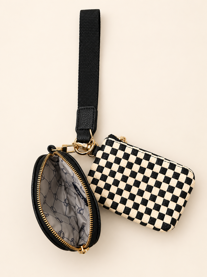 Open Black Checkered Wonderlust Dual Pouch Wristlet showing the patterned interior lining and zippered compartments.