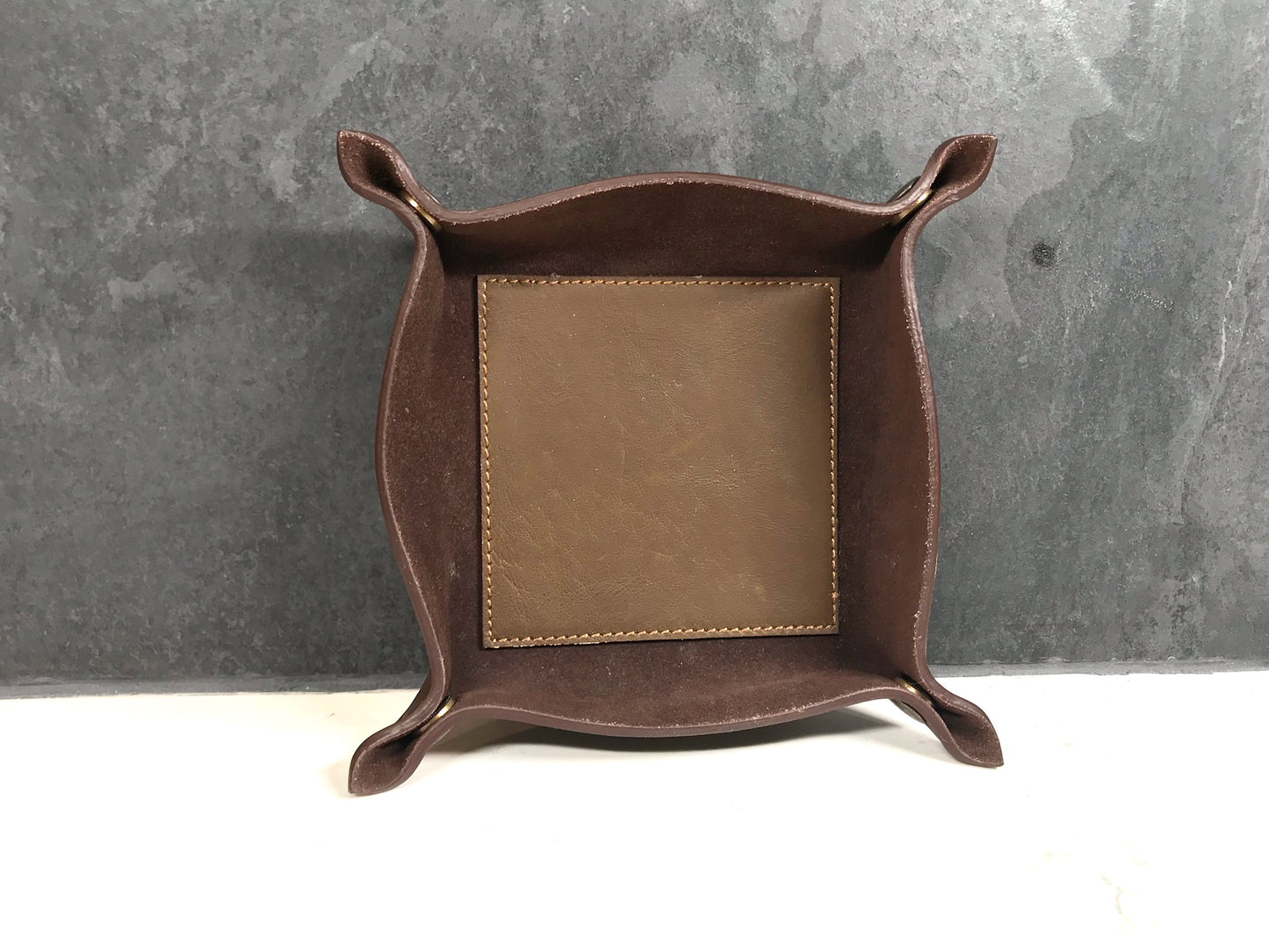 Brown leather tray with tile background