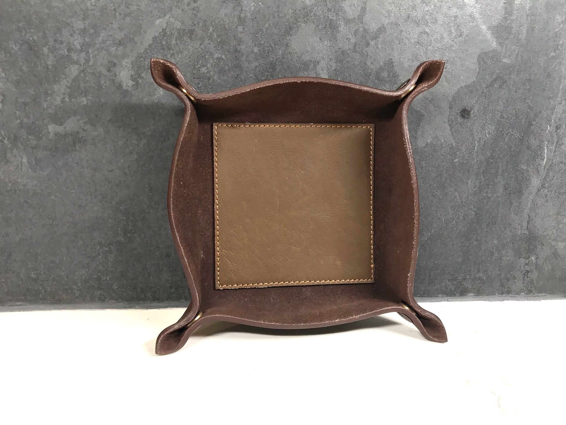 Brown leather tray with tile background