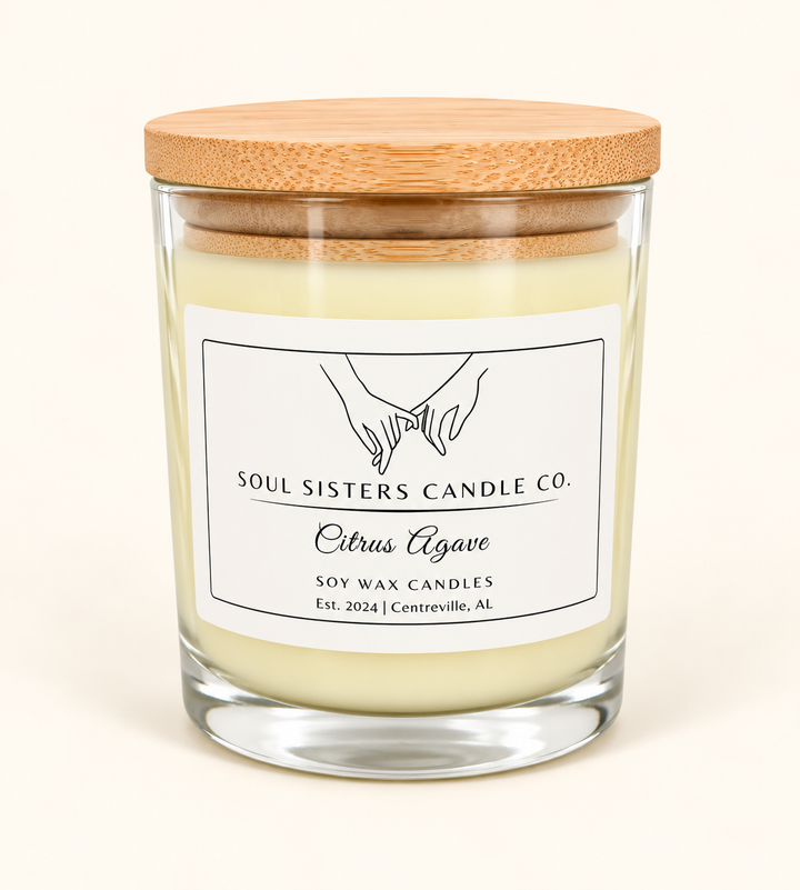 Soul Sisters Candle Co. Citrus Agave soy wax candle featuring pale ivory wax, clear glass jar, natural bamboo lid, and white branded label on a cream background.