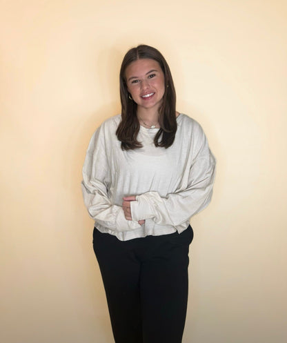 Neutral cream oversized long sleeve top styled with black pants, relaxed fit with drop shoulders, casual everyday look.
