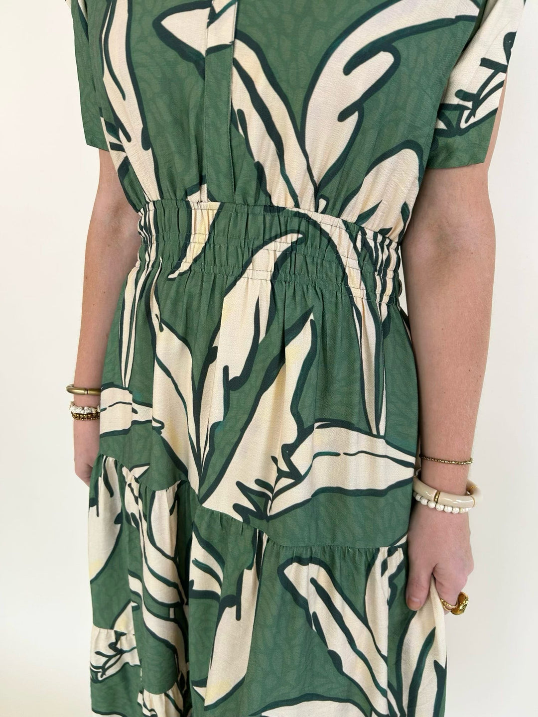 Close-up of the gathered waist and botanical leaf print on a women&