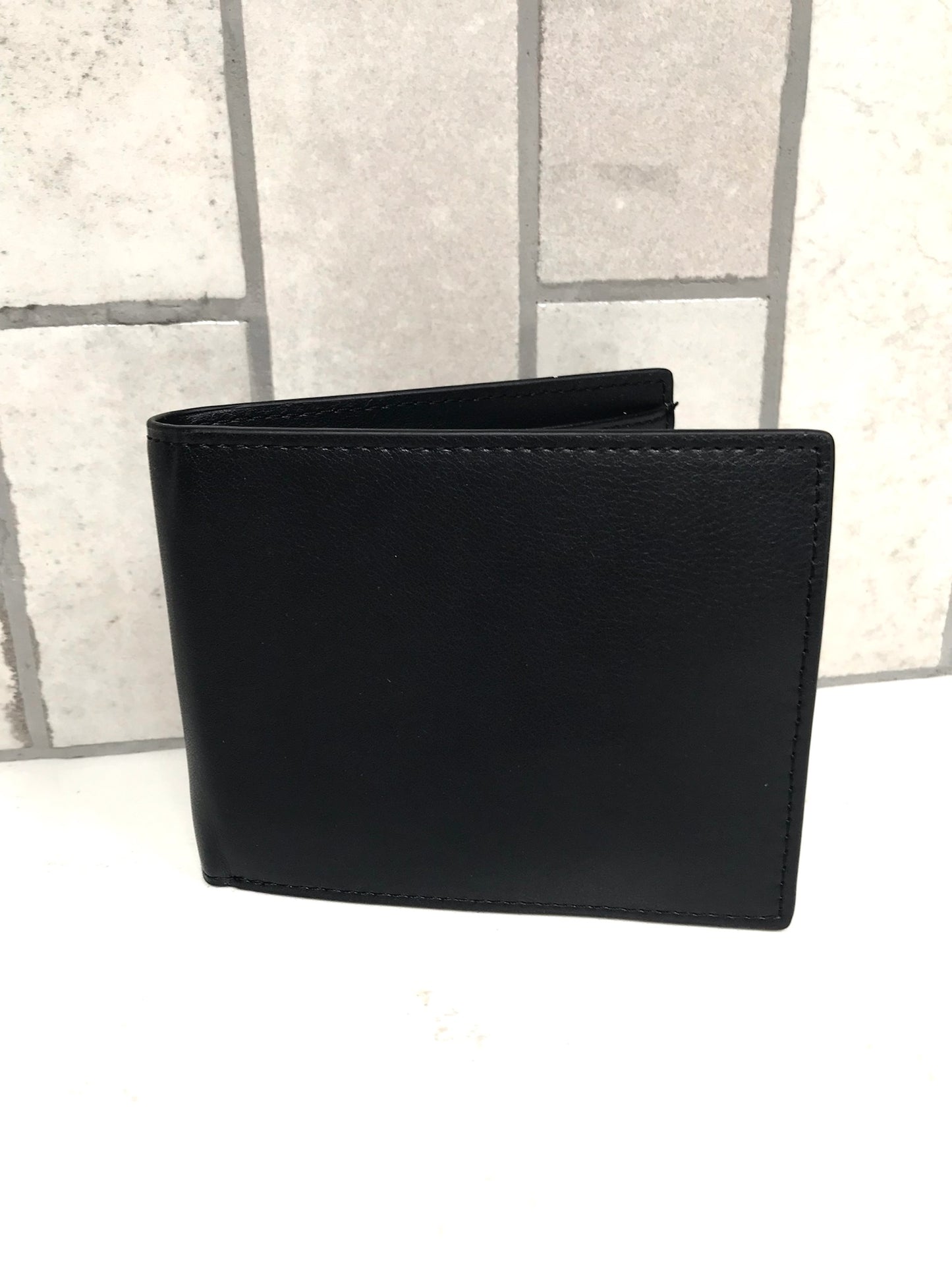 Black leather wallet on a light gray background