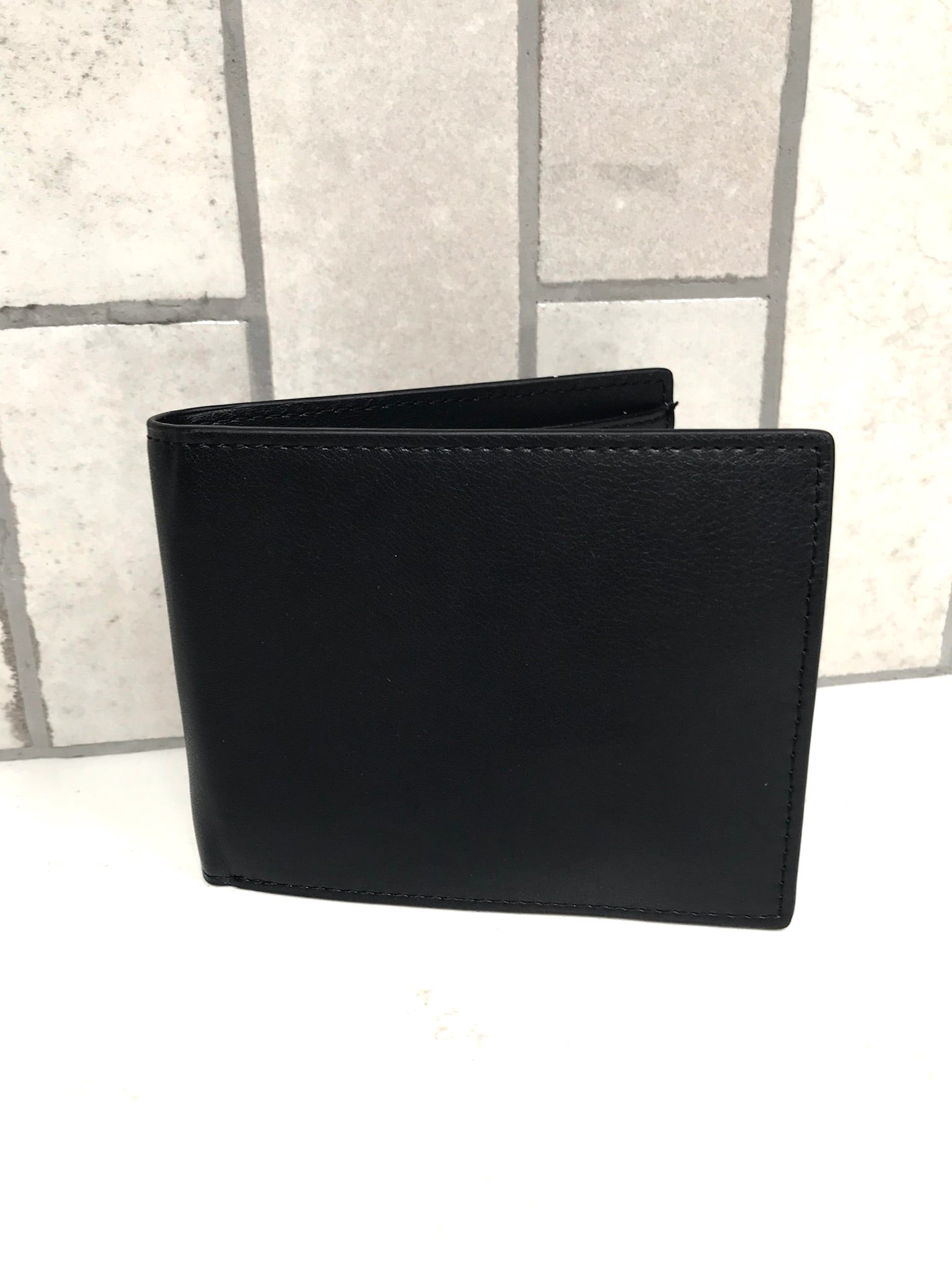 Black leather wallet on a light gray background