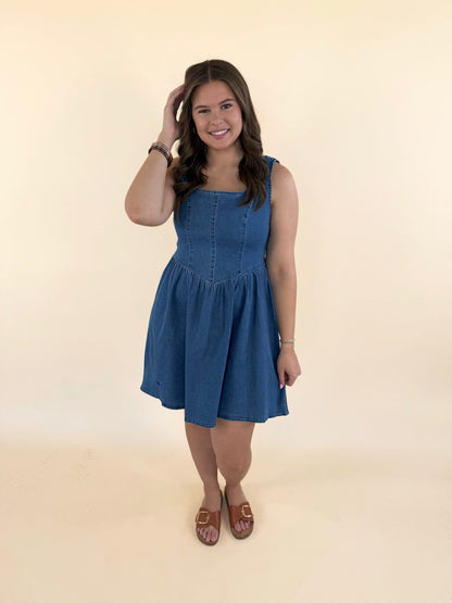 Woman modeling lightweight baby blue denim dress with flattering fit and casual summer styling