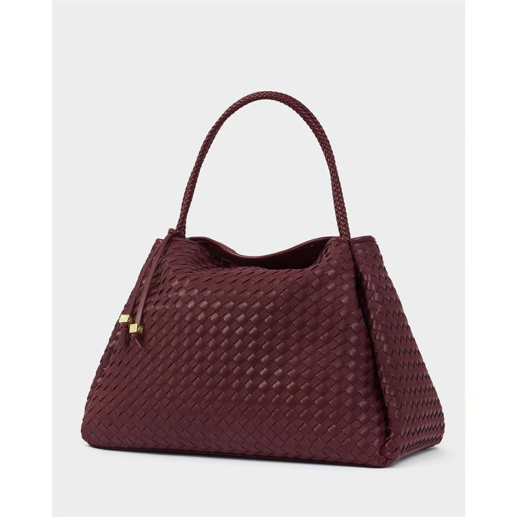 Angled view of Katie Loxton Nova Hand Woven Large Shoulder Bag in Cherry Mixed featuring braided handles and spacious woven silhouette.