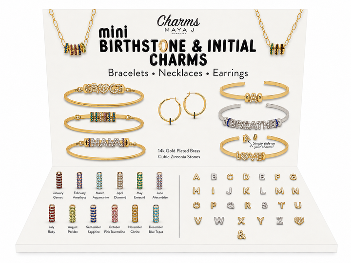 Charms Mayaj mini Birthstone &amp; Initial Charms jewelry display set showing gold-plated brass bracelets, necklaces, earrings, alphabet initial charms, and multiple colorful birthstone charms on a white background.