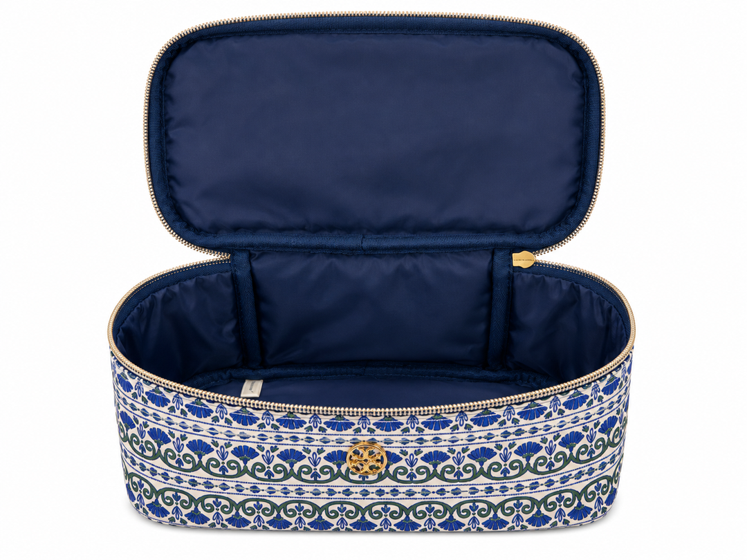 Open blue and white patterned cosmetic travel case featuring a large structured interior, wide zip opening, and roomy compartment for organizing makeup, skincare, and beauty products.