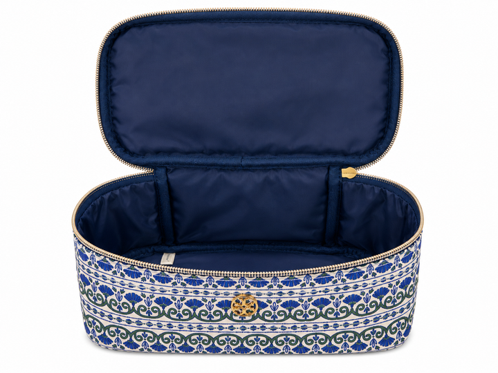 Open blue and white patterned cosmetic travel case featuring a large structured interior, wide zip opening, and roomy compartment for organizing makeup, skincare, and beauty products.