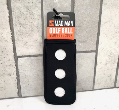 Black neoprene sock with golf balls on a gray tiled background