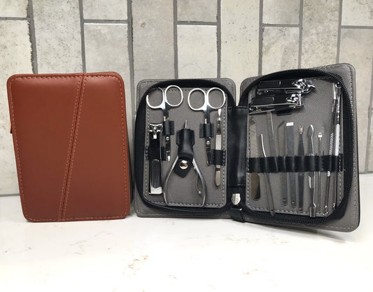 Manicure set with tools in an open case on a white surface with a tiled wall background