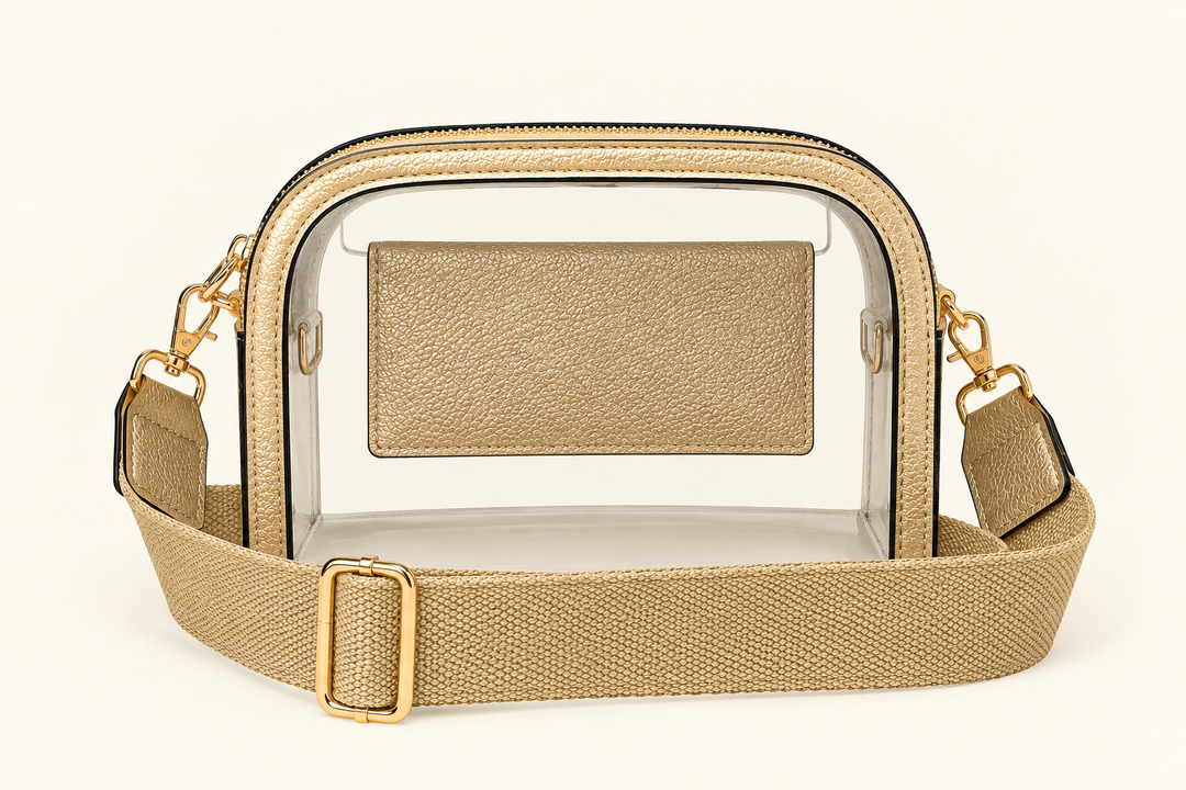 The Sideline Clear Crossbody Bag in gold with transparent PVC body, wide adjustable strap and gold-tone hardware