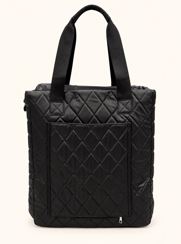 Rear view of Simply Southern black quilted tote bag showing sturdy shoulder straps, diamond stitched exterior, and large back storage pocket.