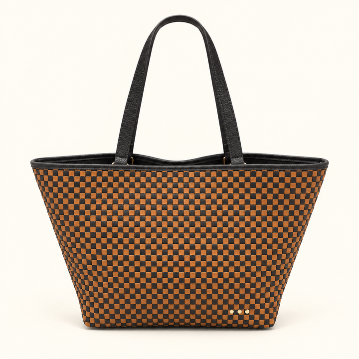 A structured tote bag featuring a brown and tan checkerboard pattern with black handles and trim, photographed against a clean off-white background.