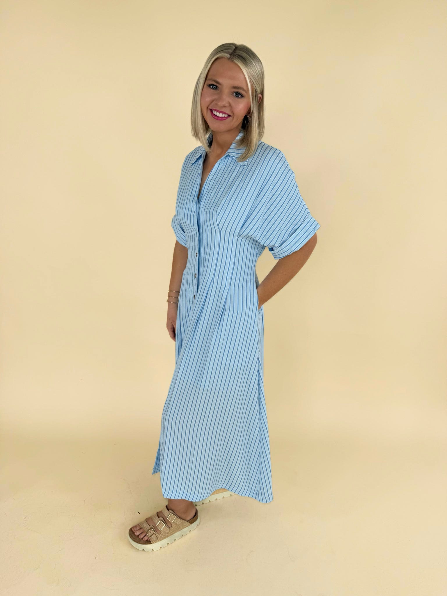 Light blue striped button down midi dress side view with short sleeves women’s boutique dress