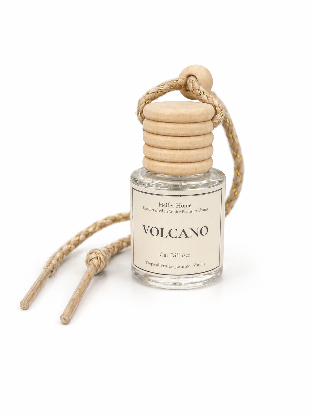 Heifer Home Volcano hanging car diffuser with natural wooden cap and braided cord featuring a tropical fruits, jasmine, and vanilla fragrance.