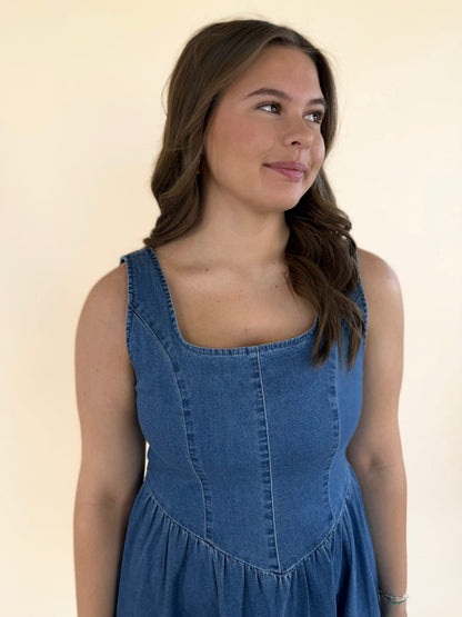 Close-up of baby blue denim dress with structured bodice and scoop neckline detail