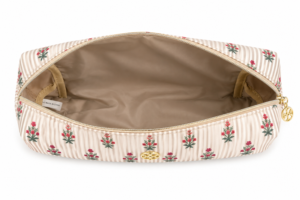 Open beige striped cosmetic bag with pink floral print, roomy interior, and gold zipper, perfect for organizing makeup, skincare, toiletries, and travel essentials.