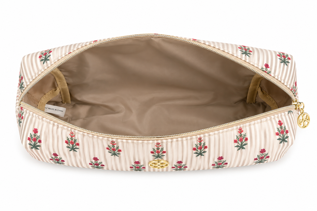 Open beige striped cosmetic bag with pink floral print, roomy interior, and gold zipper, perfect for organizing makeup, skincare, toiletries, and travel essentials.