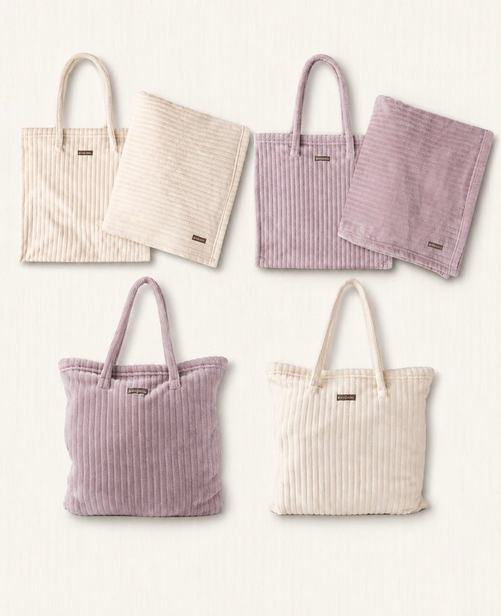 Hello Mello On My Way tote blanket collection featuring blush and ivory ribbed microfiber blankets with matching tote bags