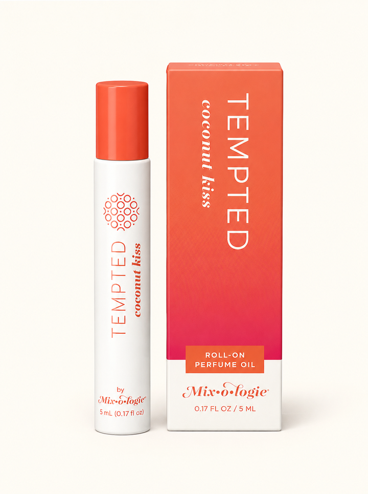 Mixologie Tempted Coconut Kiss 5 mL roll-on perfume oil with coral cap and pink-orange gradient packaging on a cream studio background.
