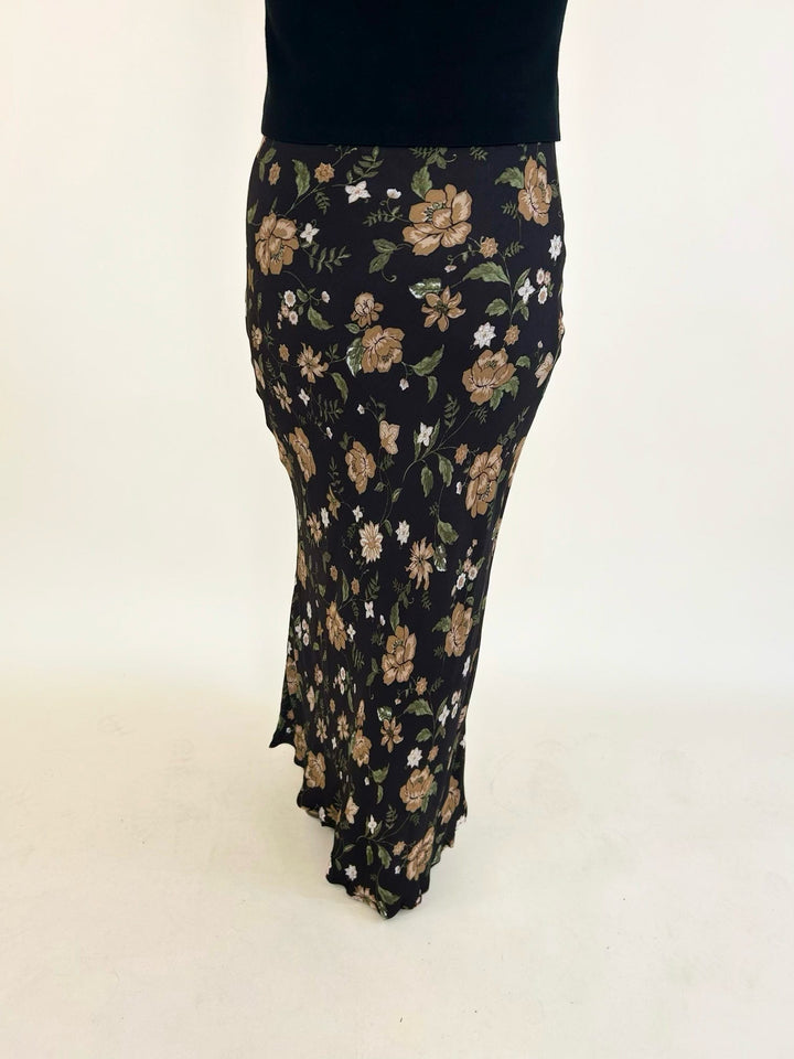 Back view of the Elaina Floral Slip-On Midi Skirt showcasing the floral print, comfortable elastic waist, and flowy silhouette.