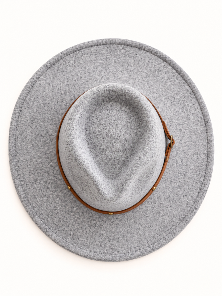 Top view of light gray wide brim western fedora hat showing the teardrop-shaped crown, textured wool blend material, stitched brim, and brown leather-style hat band on a cream background.