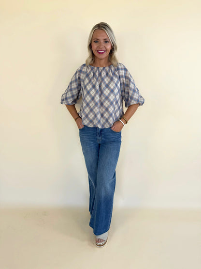 blue plaid short sleeve top women styled with high waisted wide leg jeans casual everyday outfit boutique fashion