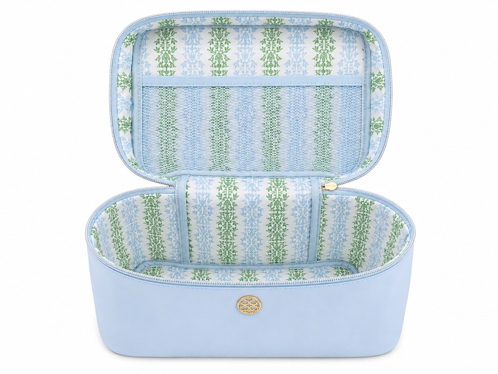 Open sky blue travel cosmetic case with spacious compartment, mesh zip pocket, patterned interior lining, and wide-opening design for organizing makeup, skincare, toiletries, an