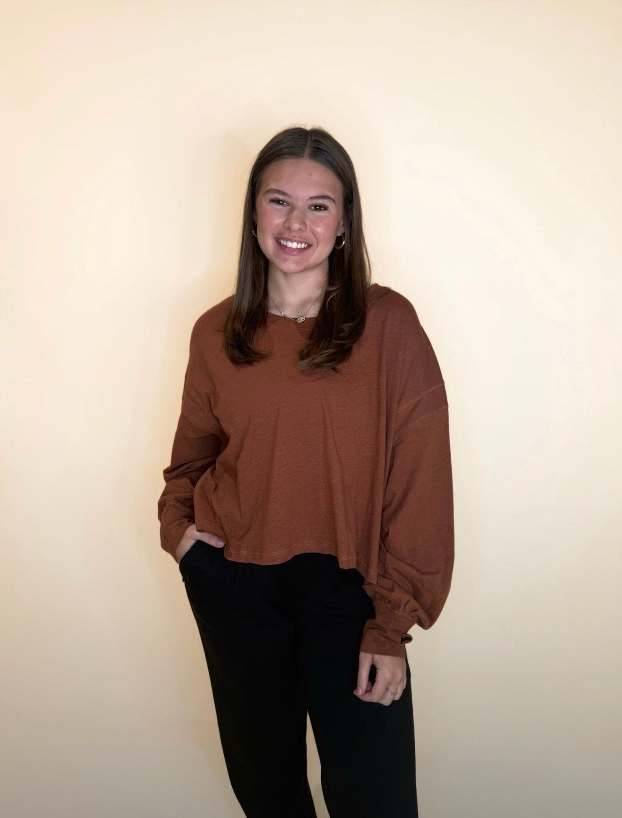 Warm cinnamon brown oversized long sleeve top with black pants, soft relaxed fit perfect for fall styling.