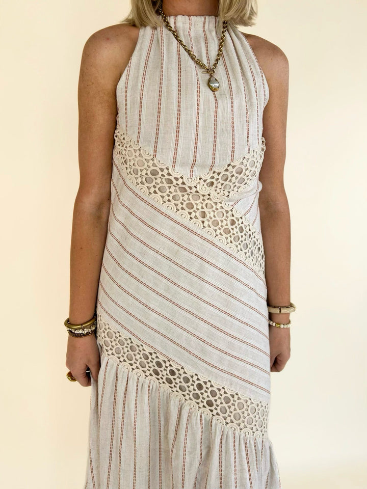 Front close-up of the Bella Halter Cutout Tiered Maxi Dress showcasing the halter neckline, crochet lace accents, and subtle waist cutout.