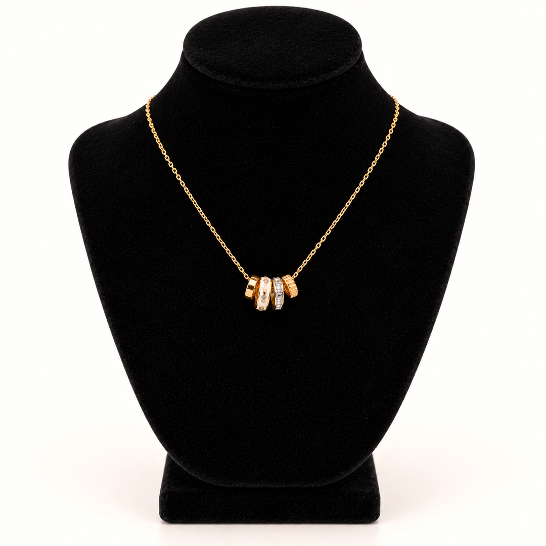 Jane Marie 16-inch gold cable chain necklace with petite 0.5-inch crystal and white rondelle pendant cluster displayed on a black velvet necklace bust against a cream background.