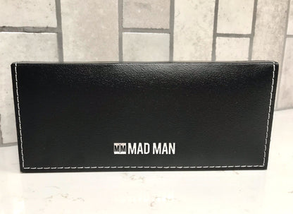 Black pen case with 'MM MAD MAN' branding on a light gray surface.
