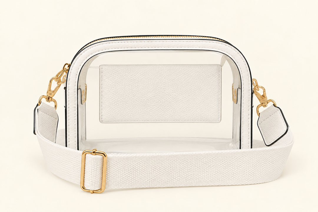 The Sideline Clear Crossbody Bag in white with adjustable woven strap and gold hardware for game days and stadium events