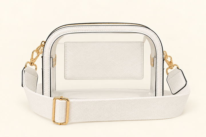 The Sideline Clear Crossbody Bag in white with adjustable woven strap and gold hardware for game days and stadium events