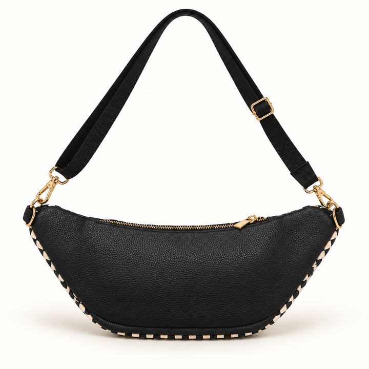 A black pebbled faux-leather crescent-shaped shoulder bag with gold-tone hardware, featuring a matching black webbing strap and decorative gold studs along the bottom edge, set against a plain white background.