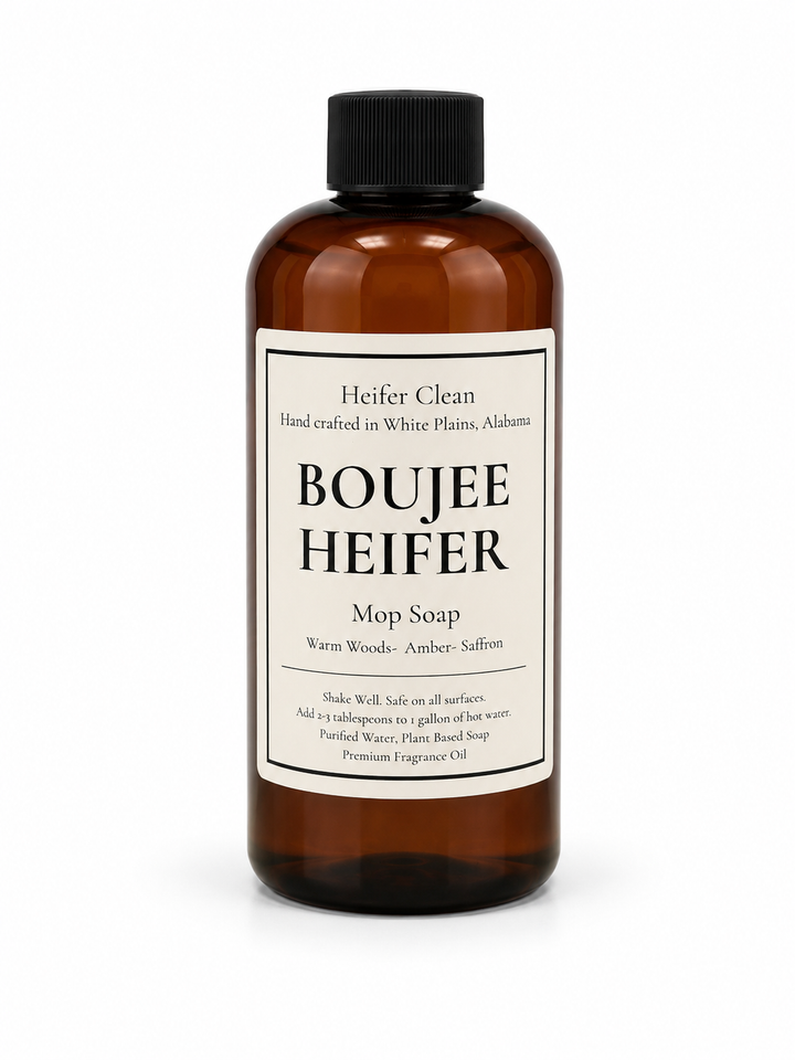 Heifer Clean Boujee Heifer scented mop soap in an amber bottle featuring warm woods, amber, and saffron fragrance for cleaning all hard floor surfaces.