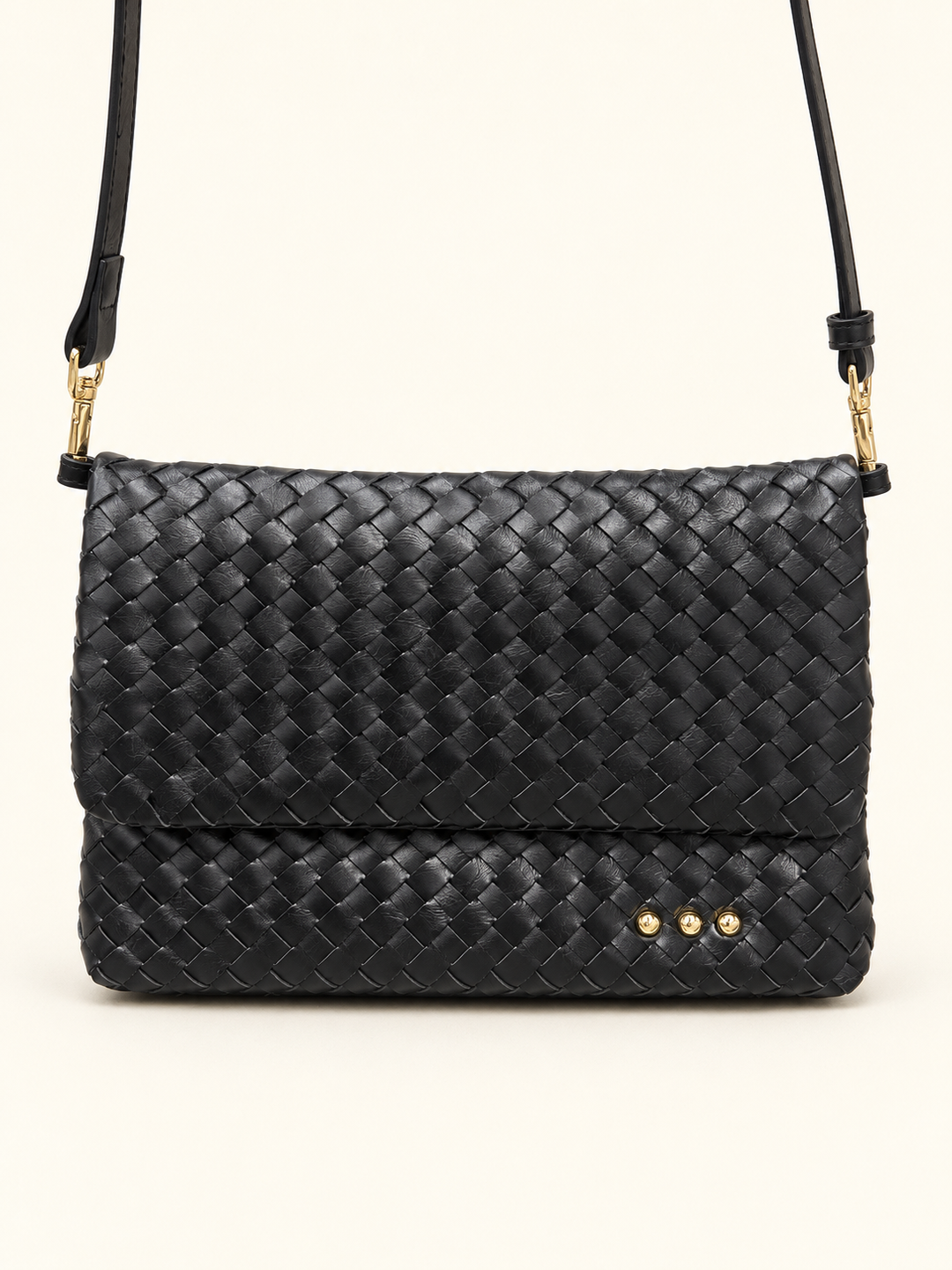 Close up view of the Wrenlee black woven crossbody bag with an adjustable shoulder strap.