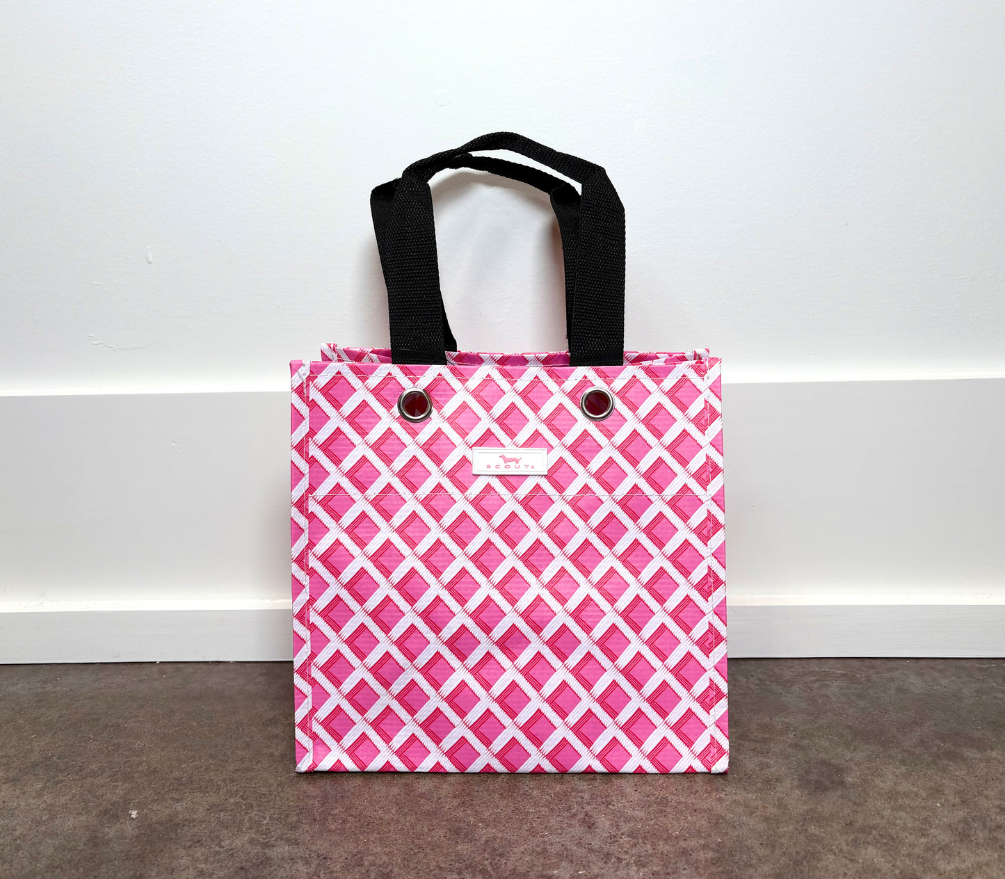 Gift Bag Small in Garden Gate pink and white lattice print, reusable gift tote with black handles.