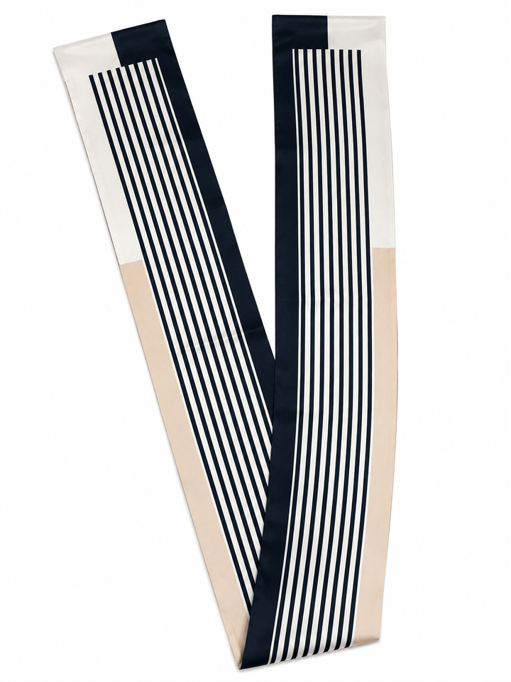 A long rectangular scarf with a color-blocked design featuring navy blue, cream, and beige sections with vertical stripe patterns, shown on a plain white background.