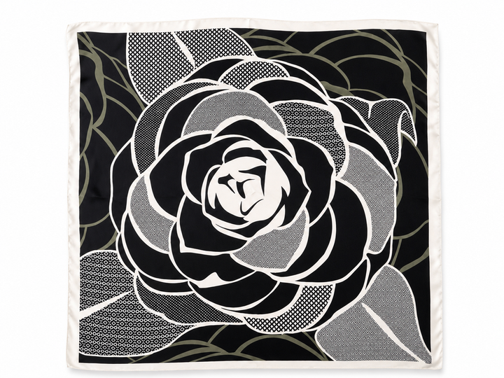 A square scarf featuring a large black and white rose design with sage patterned accents and a white border, shown flat against a white background.