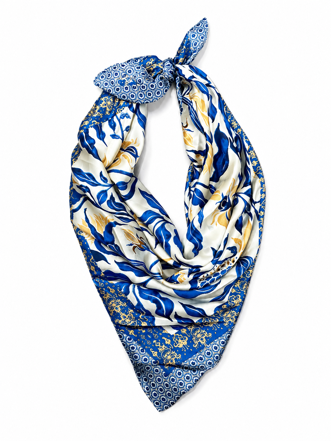 A square silk scarf with a blue, white, and nude botanical pattern, tied in a loop at the top and displayed against a solid white background.