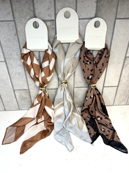 Katie Loxton Satin Multiway Scarf collection featuring ripple stripe, caramel checker, and mocha leopard prints.
