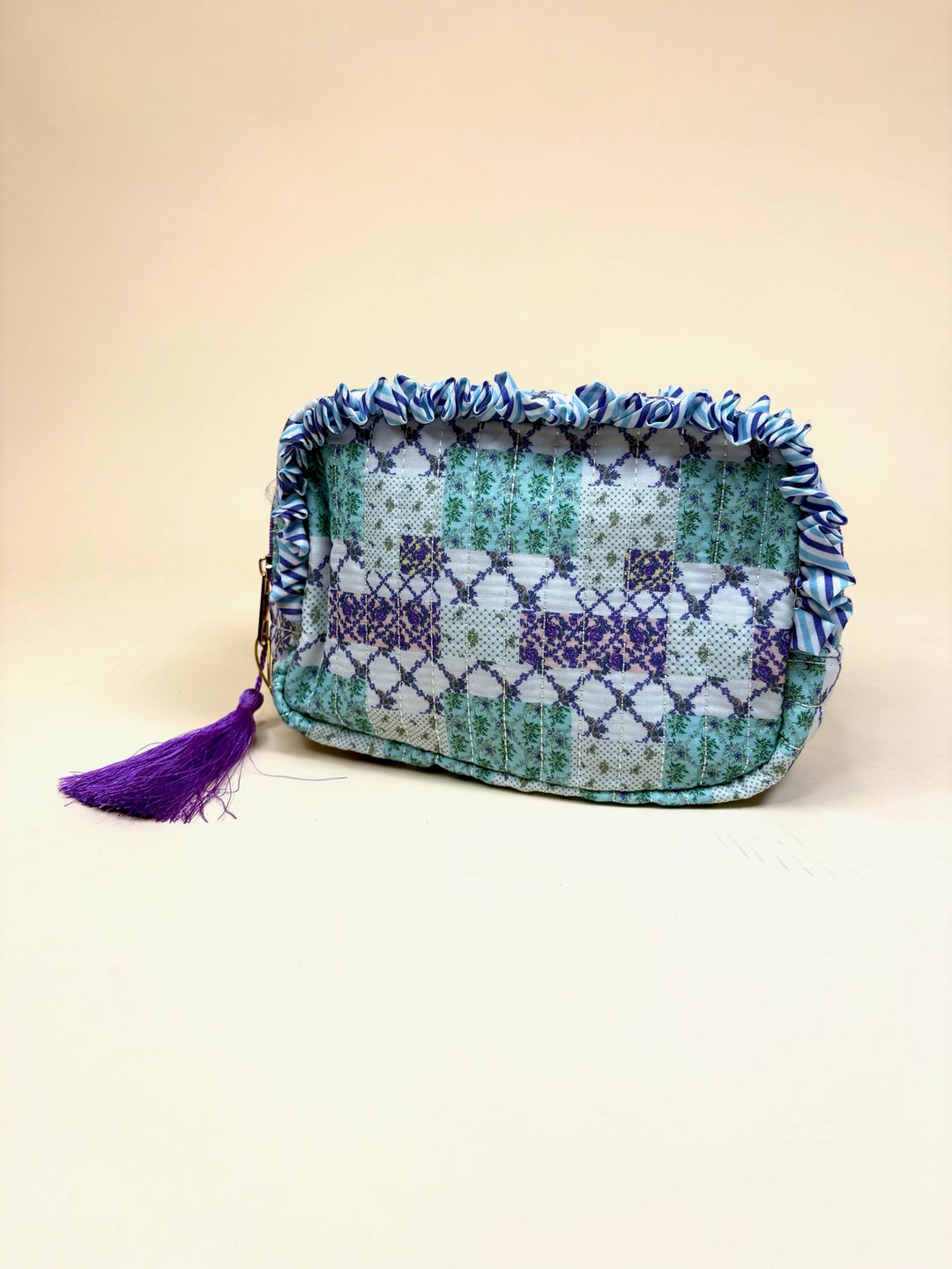 Simply Southern Trail Patch quilted cosmetic bag with ruffle trim, purple tassel zipper pull, and zip-top closure.